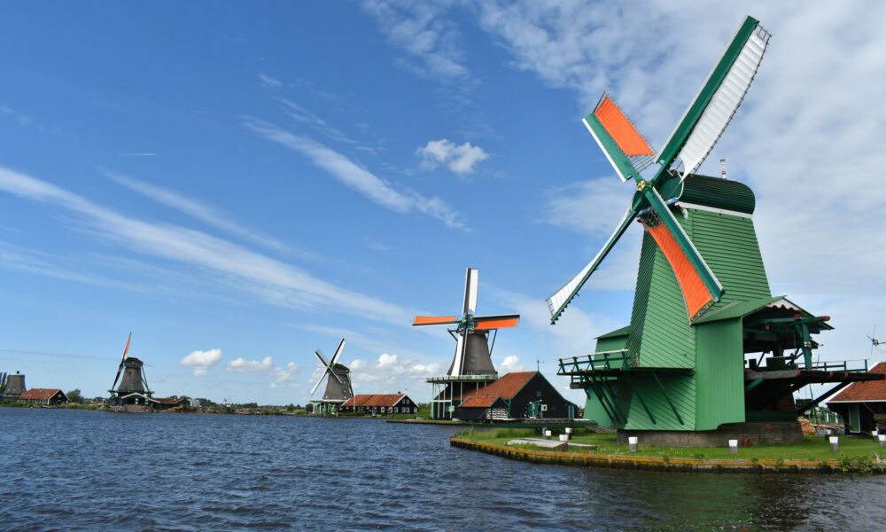 Traditional Dutch windmills on a lake. Classic Dutch scenery.